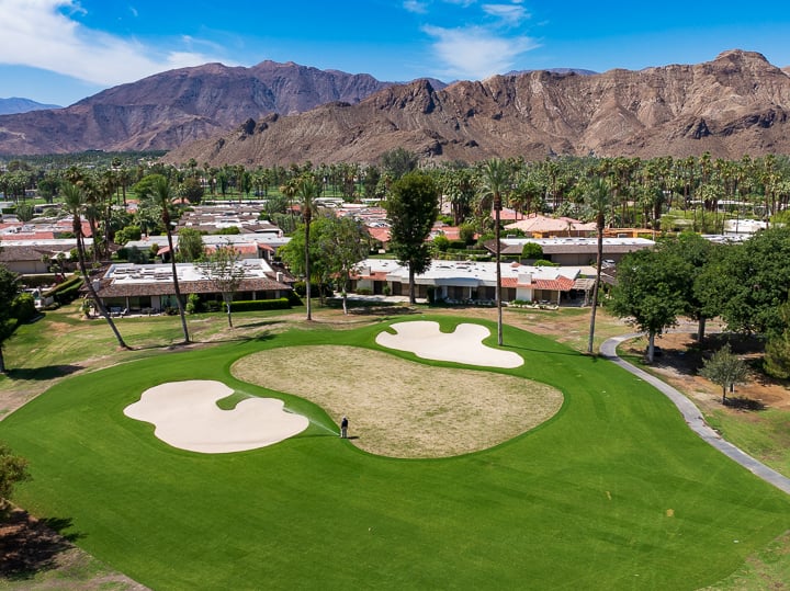 Aerial view of the newly renovated Hole 1 green at The Springs Country Club, highlighting the green's contours and desert landscape.