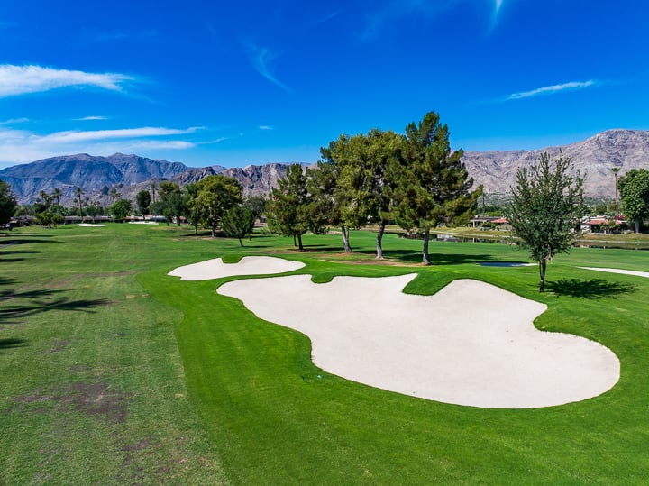 Aerial view of the bunkers surrounding Hole 1 at The Springs Country Club, highlighting their design and placement near the green.