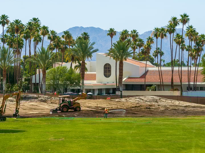 Scenic shot of the clubhouse at The Springs, viewed from Hole 6 with the club logo visible on the building.