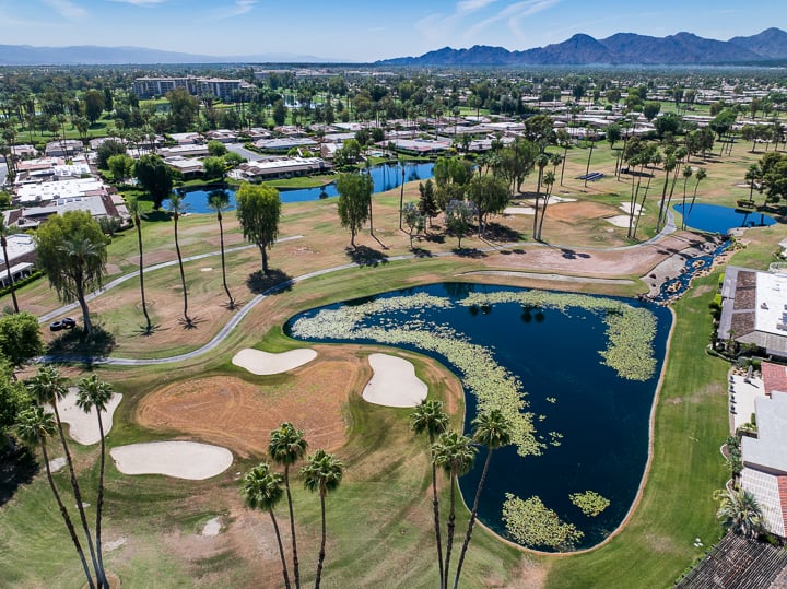 Hole 8 with turf browned and inactive, showing a pre-demolition state after grass kill, ready for removal and renovation work.