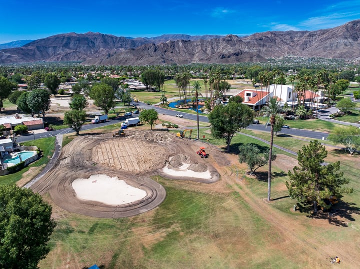 Hole 9 at The Springs Country Club during demolition, with tractors actively tearing up the turf and reshaping the landscape as part of the renovation project.