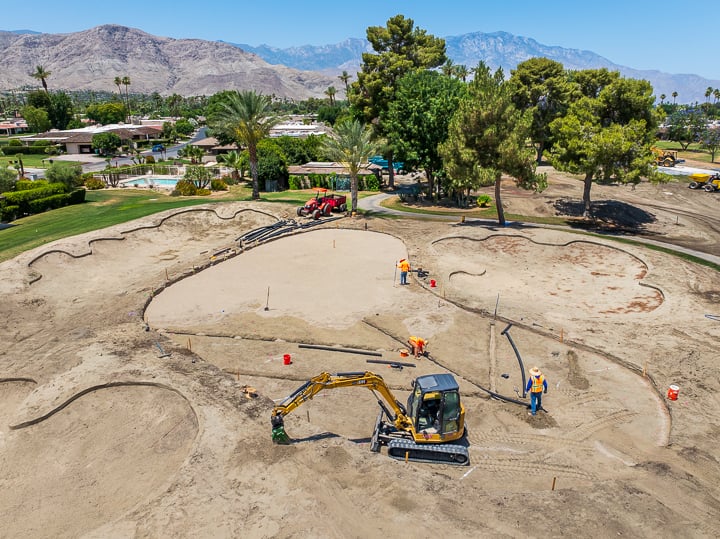 Overhead image of Hole 15 with active drainage work on the green, illustrating subsurface infrastructure improvements.