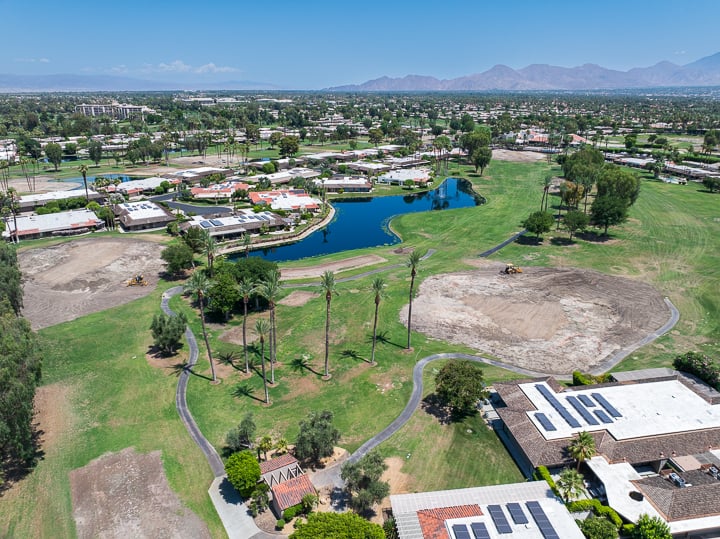 Aerial view of Hole 5 (far left) and Hole 4 (short right) at The Springs Country Club following green demolition, showing cleared surfaces and active renovation zones.