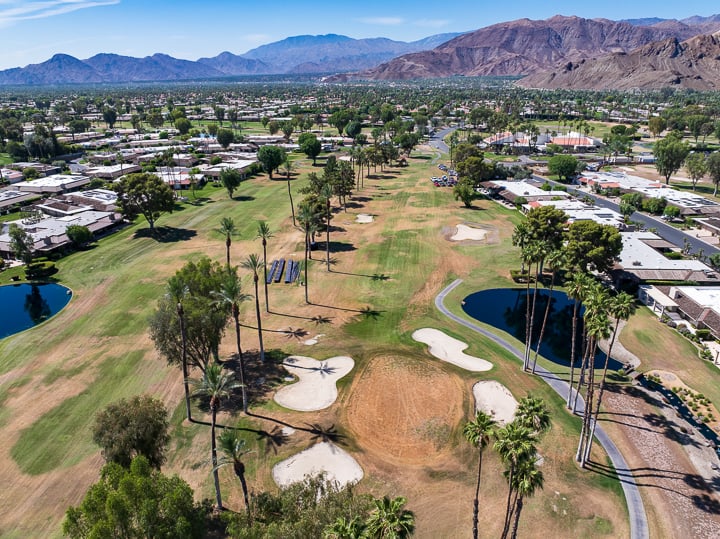 Hole 7 at The Springs Country Club prior to renovation, showing the original green, fairway, and surrounding landscape in its classic layout.